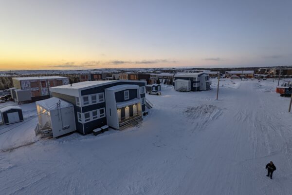 Snowy sunrise over modern, isolated buildings.