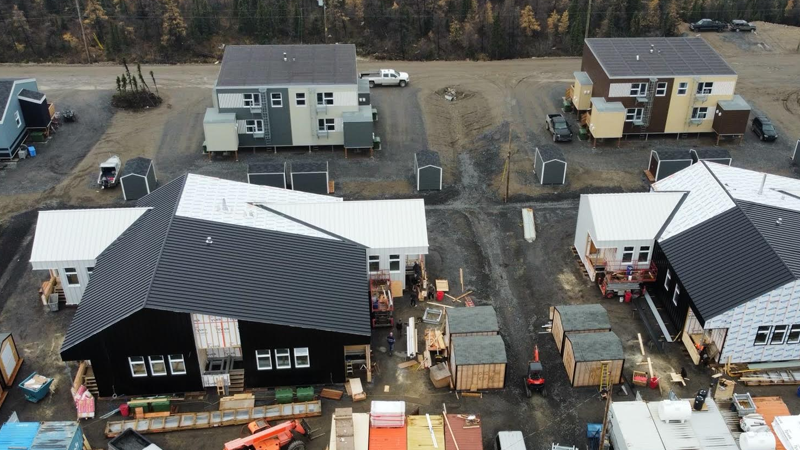 Aerial view of houses under construction in rural area.
